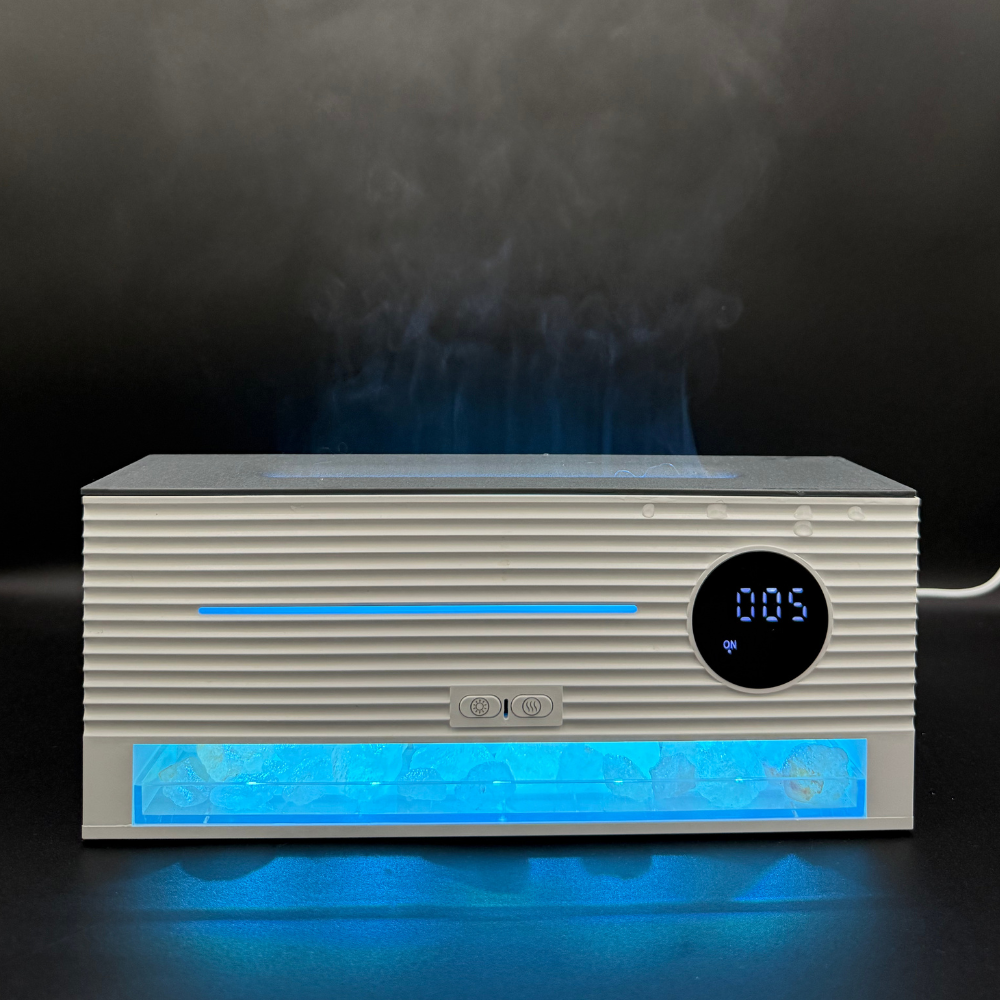Amber Glow flame-effect diffuser by Illumaluxe featuring cool blue LED light, ultrasonic mist, and digital clock display for calming aromatherapy