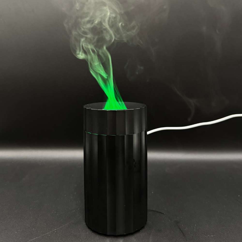 Matte Black USB aroma diffuser emitting green LED mist for car or home aromatherapy by Illumaluxe