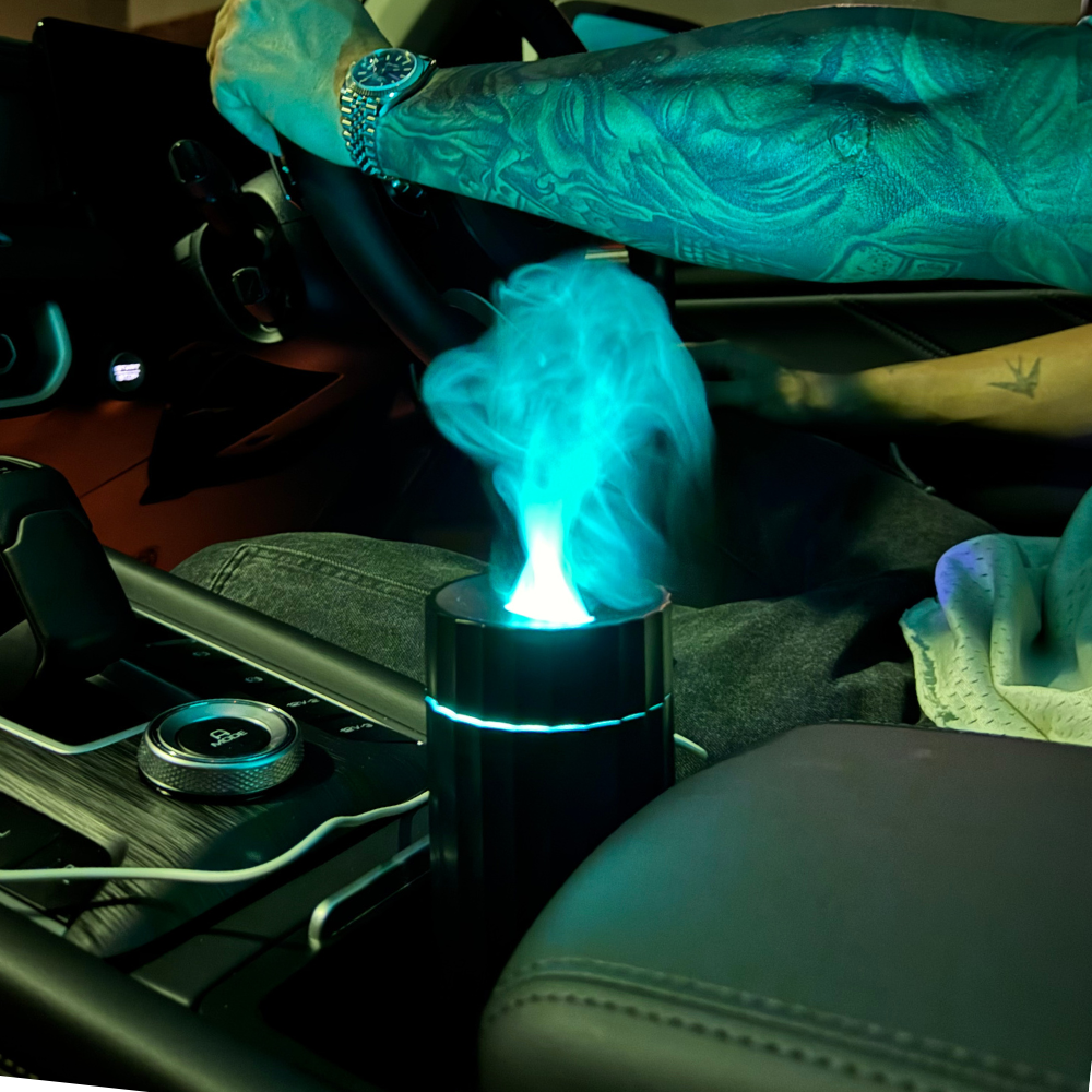 Illumaluxe black USB diffuser releasing mist while placed in a car cup holder – portable aromatherapy for vehicles